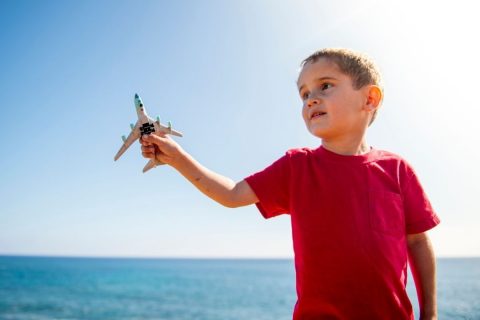 4 year old child holding a toy airplane