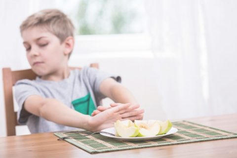 Child refusing a plate of food