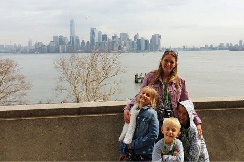 Family on Ellis Island looking back to the New York skyline