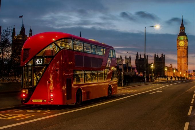 Red doubel decker bus passing in front of Big Ben