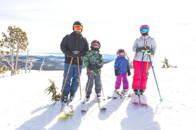 Family of 4 wearing ski gear - ski packing list