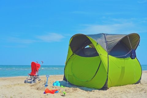 Green tent on a beach for families