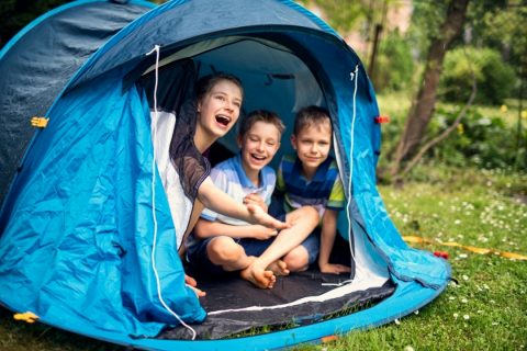 Kids laughing inside a tent