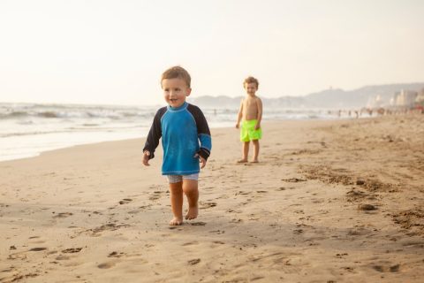 two toddler boys on a beach