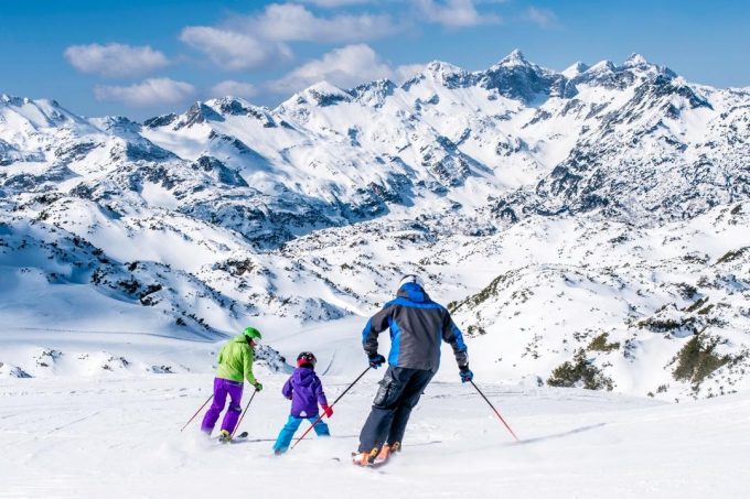 family skiing in europe during winter holiday