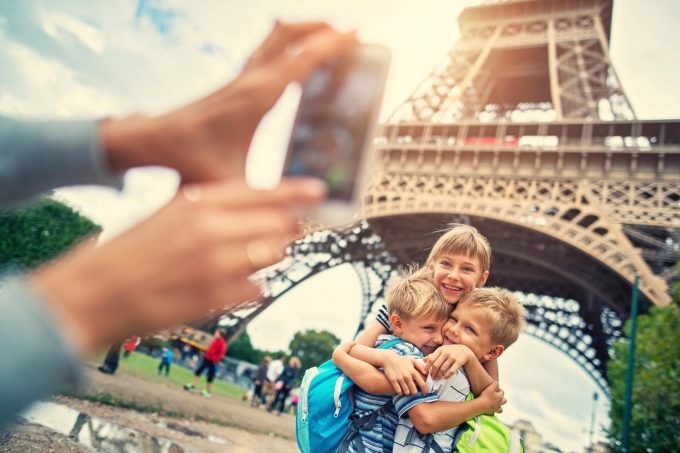 Family posting for a photo under the Eiffel tower