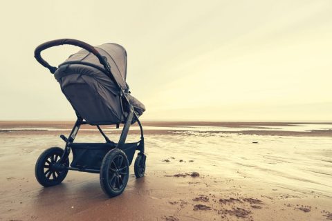 a stroller parked on the beach