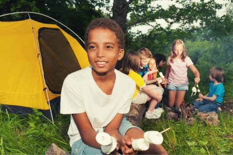 kids at a campsite with marshmallows