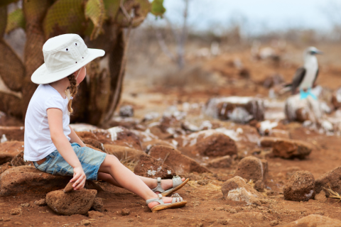 A girl sitting observing wildlife on Galapagos