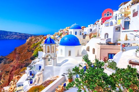 Oai on Santorini Island blue roofs on white houses on a stunning sunny blue sky day in the Greek Islands