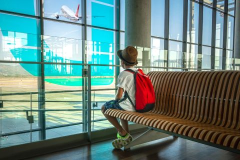 a child sitting alone in an airport