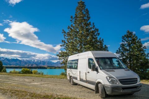 A campervan in New Zealand parked next to a lake