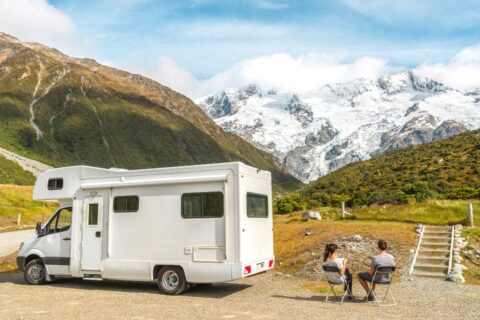 campervan in New zealand with couple taking a picnic
